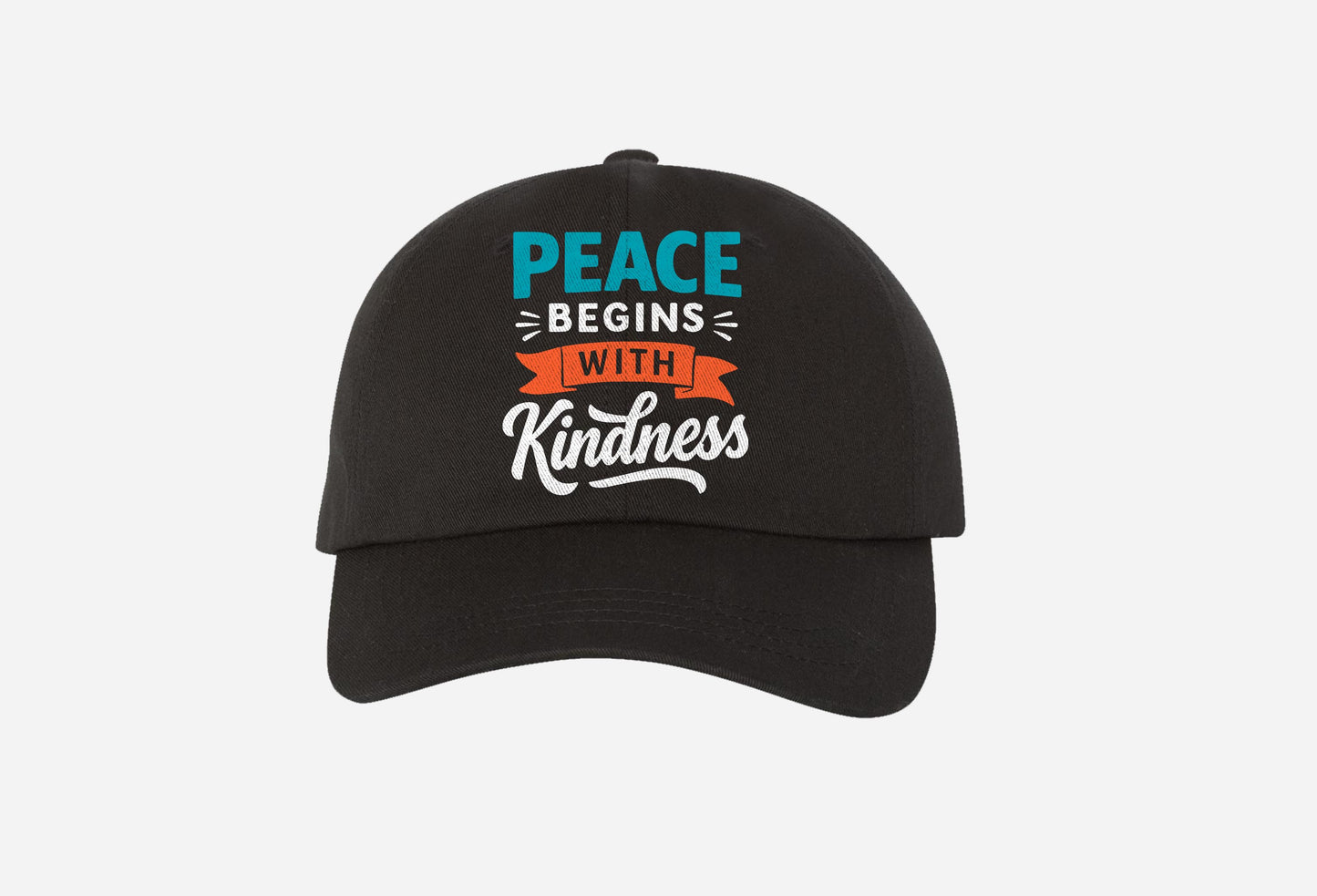 black baseball cap with colorful embroidered text 'peace begins with kindness' on front.
