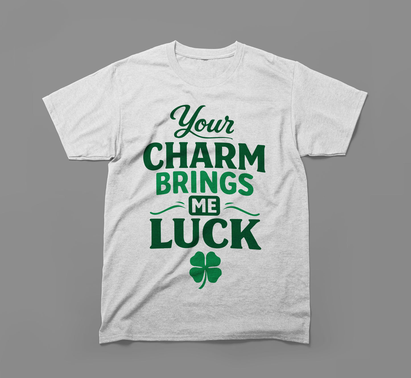 white t-shirt with green text 'your charm brings me luck' and a four-leaf clover graphic