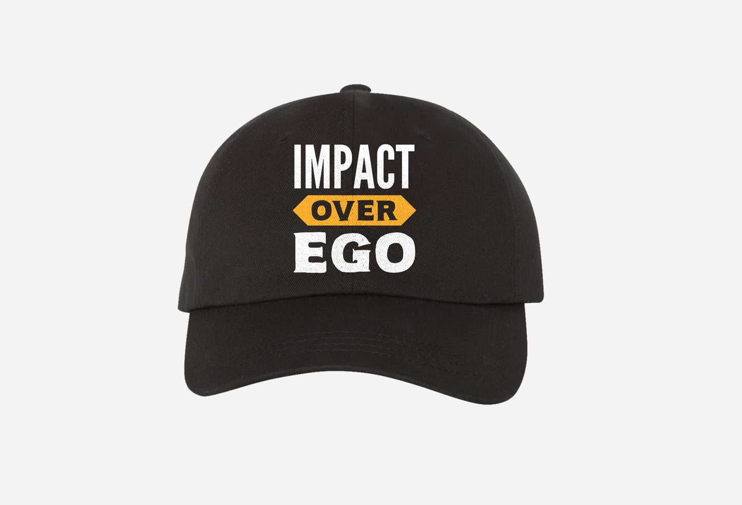 black baseball cap with 'impact over ego' text and yellow accent on white background.