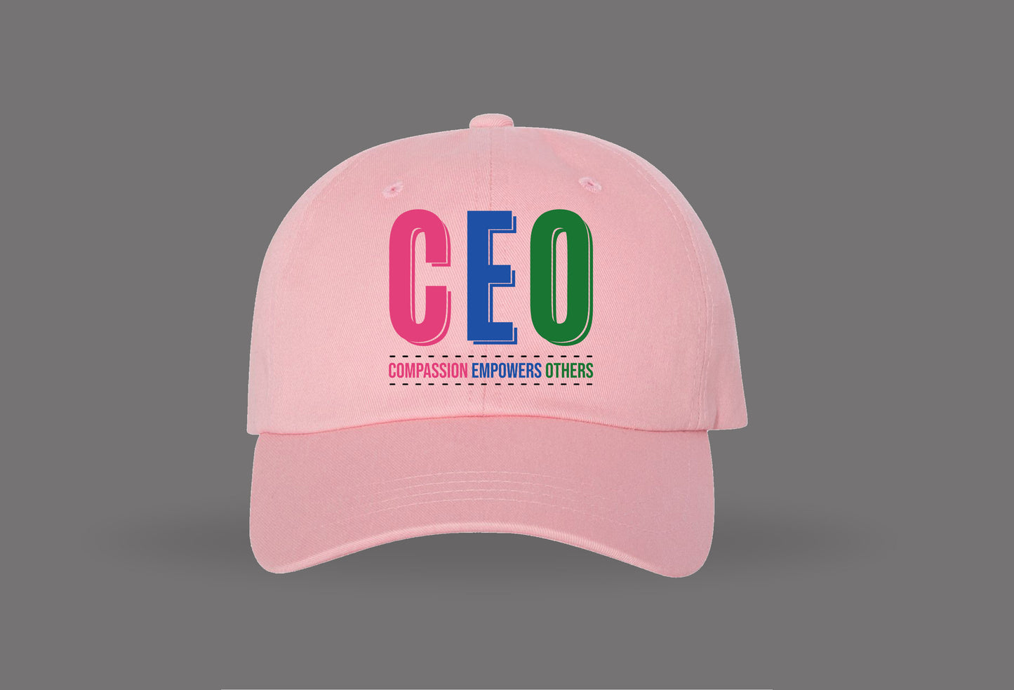 pink baseball cap with colorful ceo text and 'compassion empowers others' slogan on front