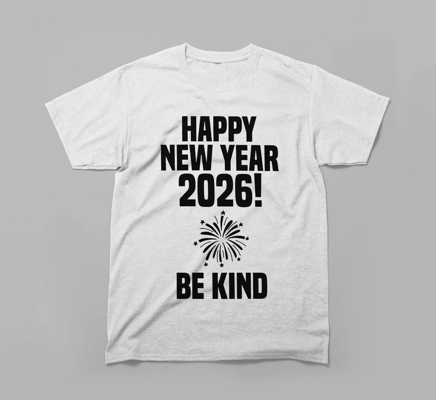 white t-shirt with happy new year 2026 and be kind message and a fireworks graphic.