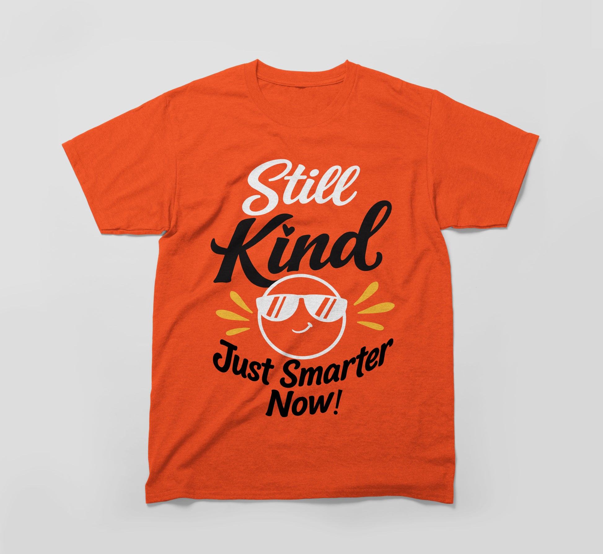 Orange t-shirt with 'Still Kind Just Smarter Now!' and smiling sun with sunglasses graphic.