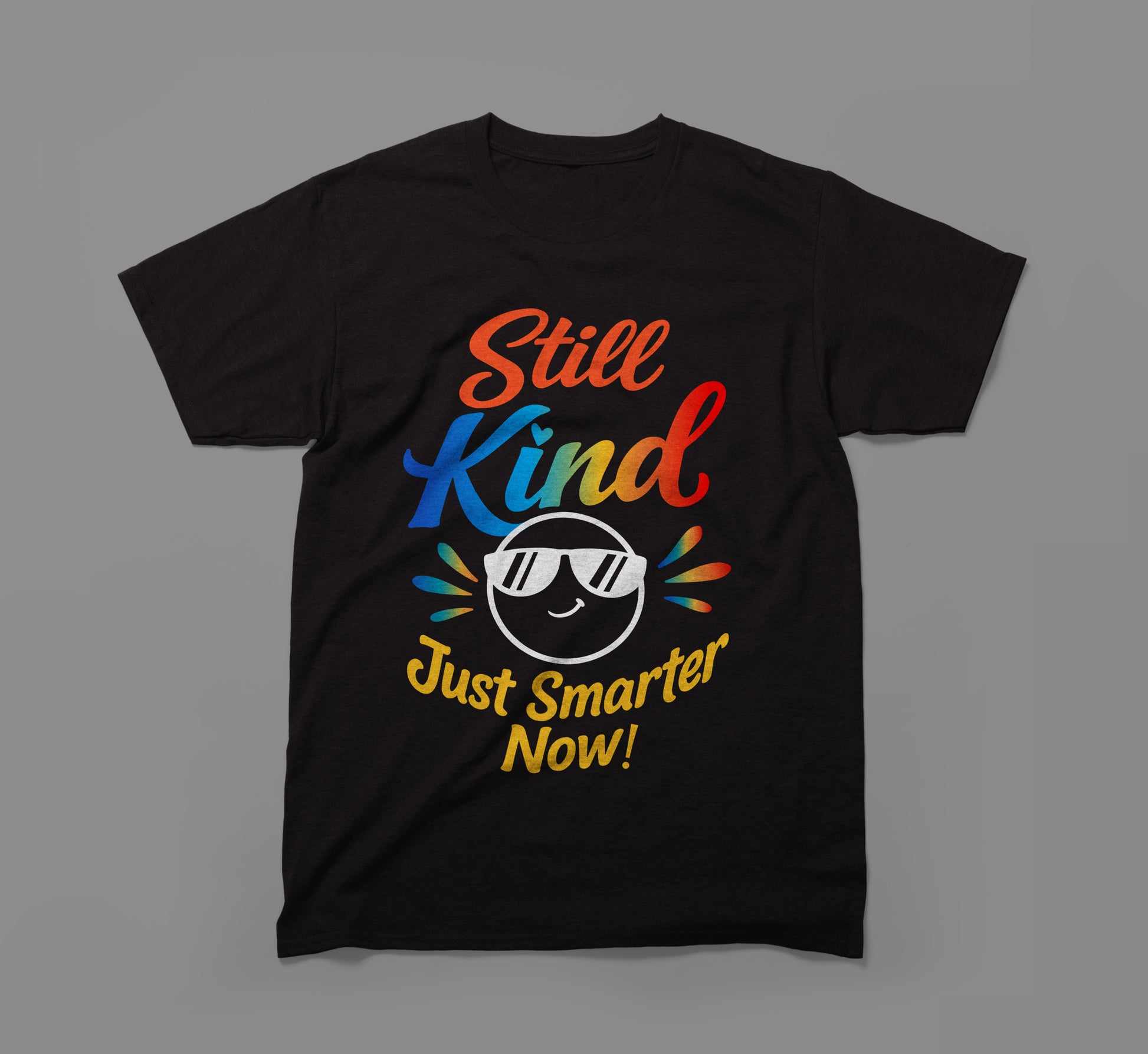 Black t-shirt with colorful 'Still Kind Just Smarter Now!' text and smiling emoticon graphic