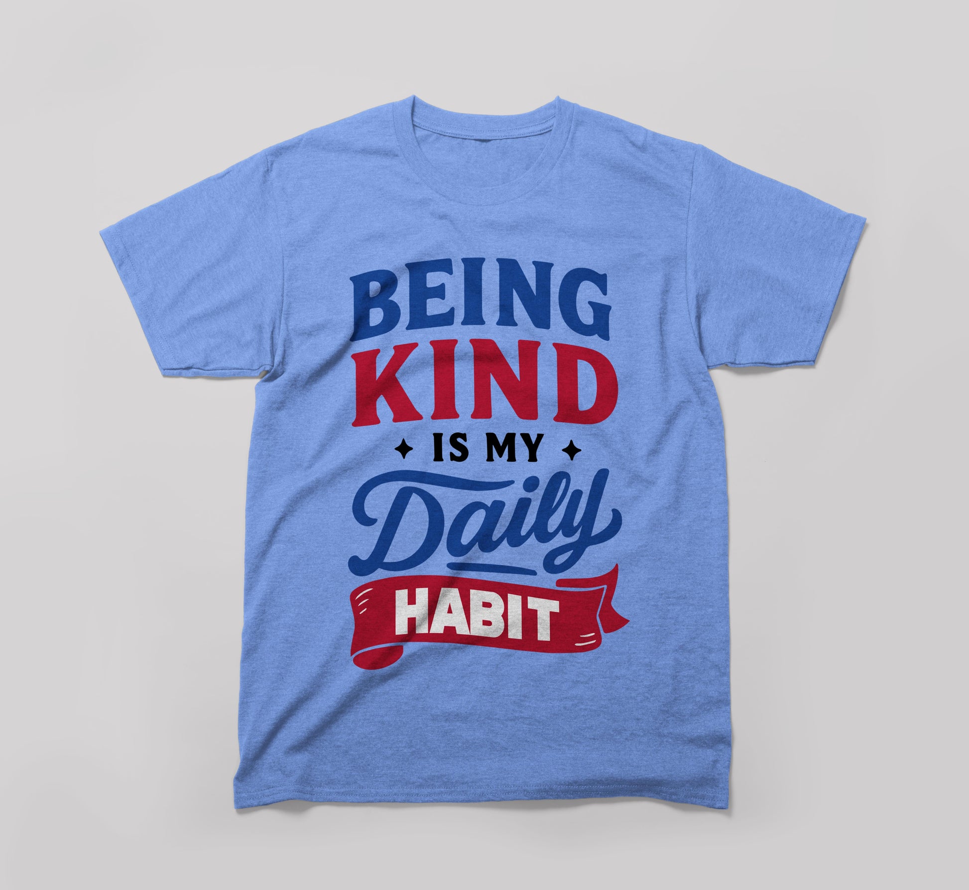 Light blue t-shirt with 'Being Kind Is My Daily Habit' motivational text graphic.