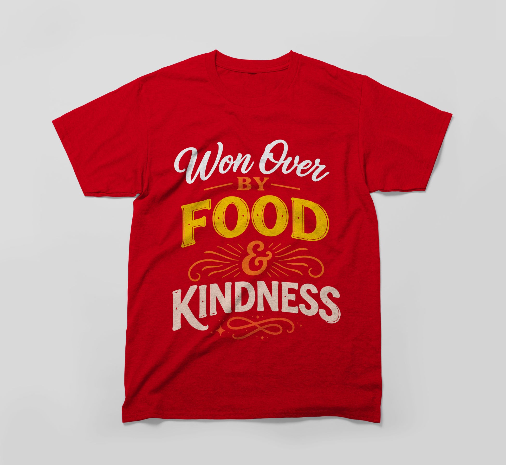 Red t-shirt with the message 'Won Over by Food & Kindness' in bold, colorful text