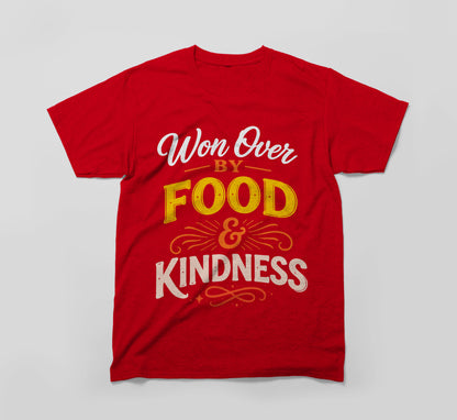 Red t-shirt with the message 'Won Over by Food & Kindness' in bold, colorful text