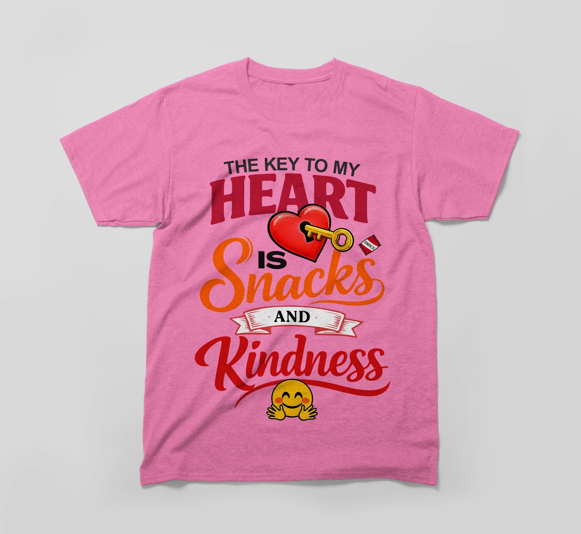 Pink t-shirt with 'The key to my heart is snacks and kindness' text, heart, key, and smiley emoji design