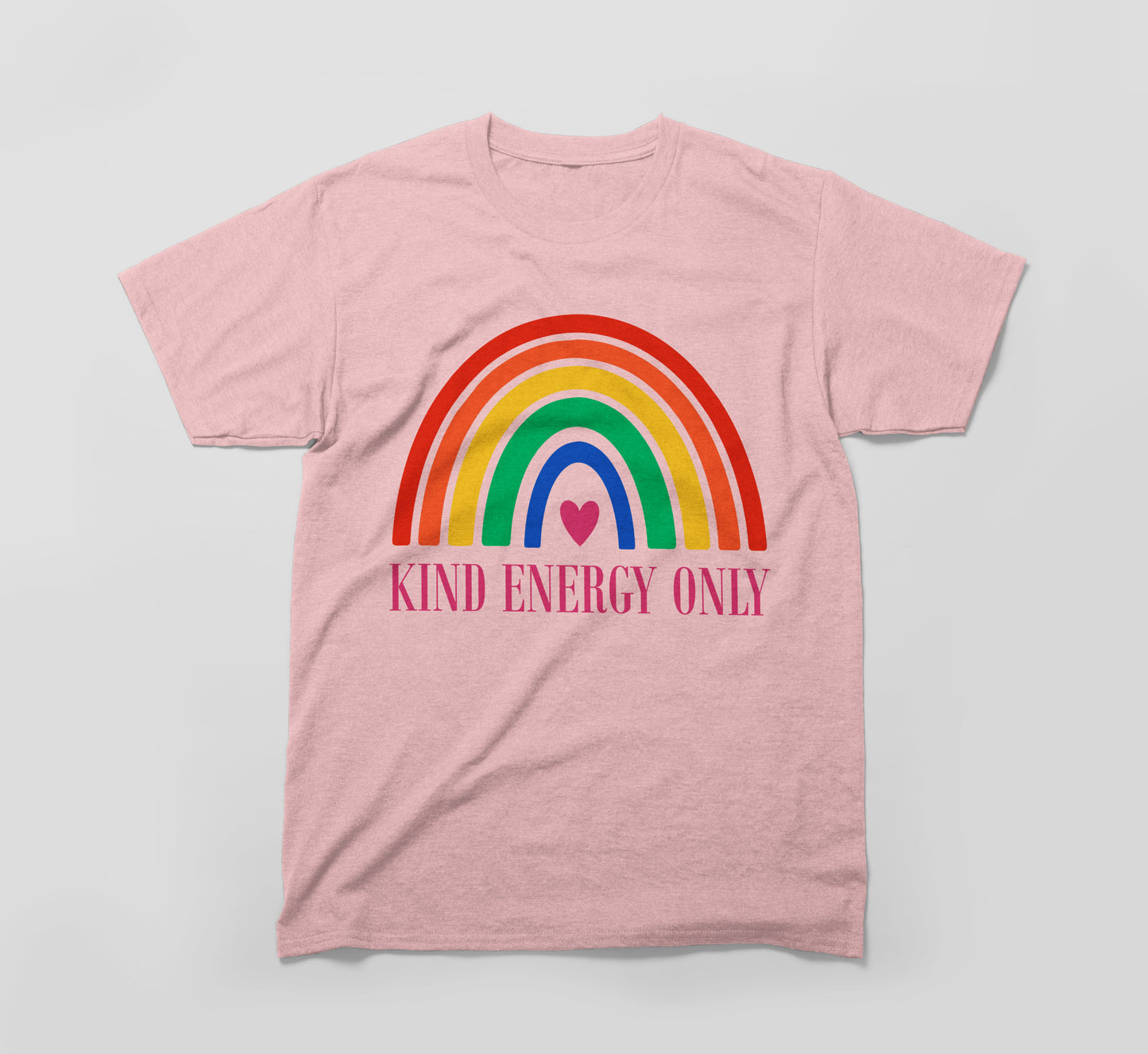 pink t-shirt with colorful rainbow, heart, and 'kind energy only' text promoting kindness.
