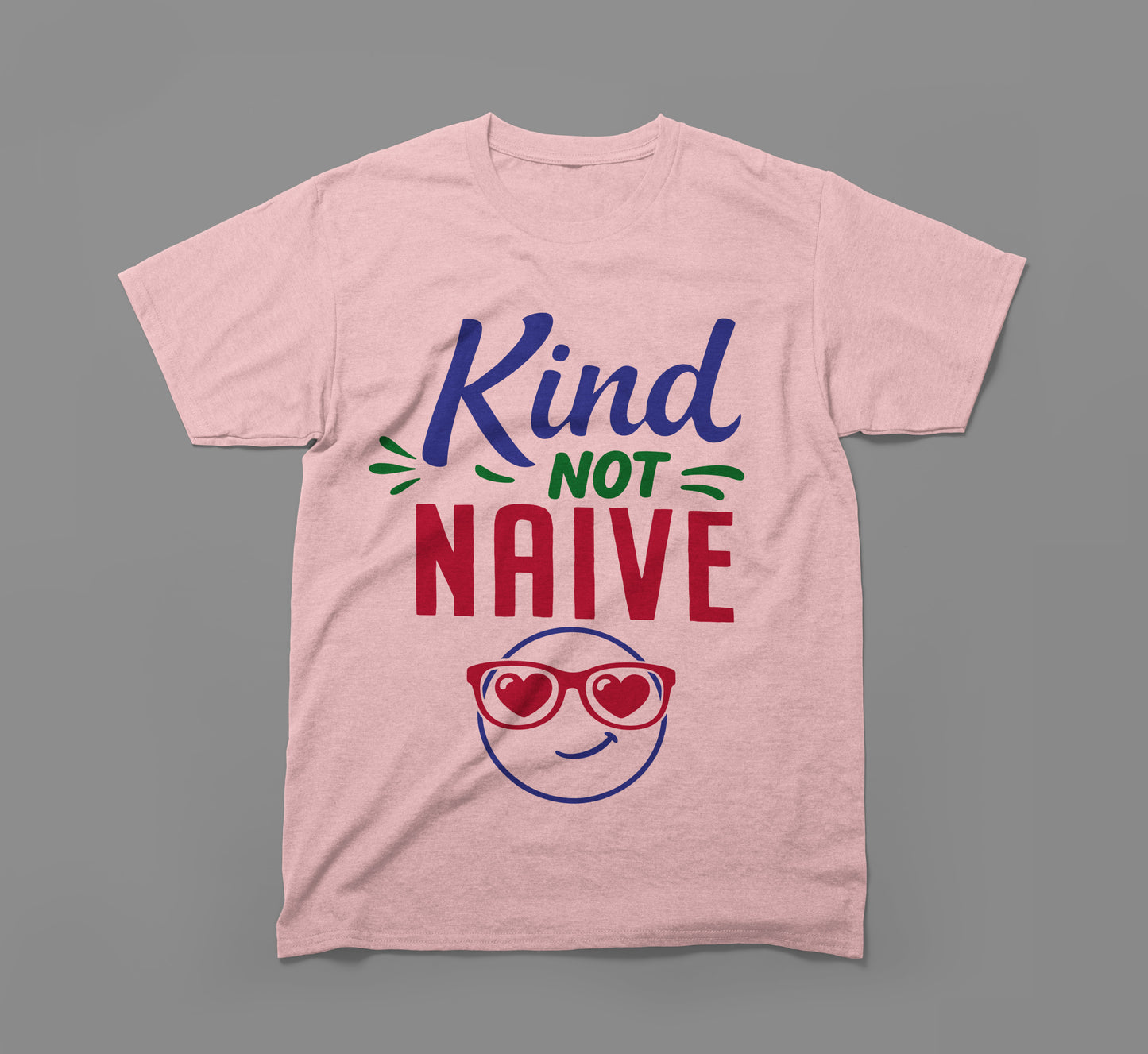 pink t-shirt with 'kind not naive' slogan and smiling face with heart sunglasses graphic